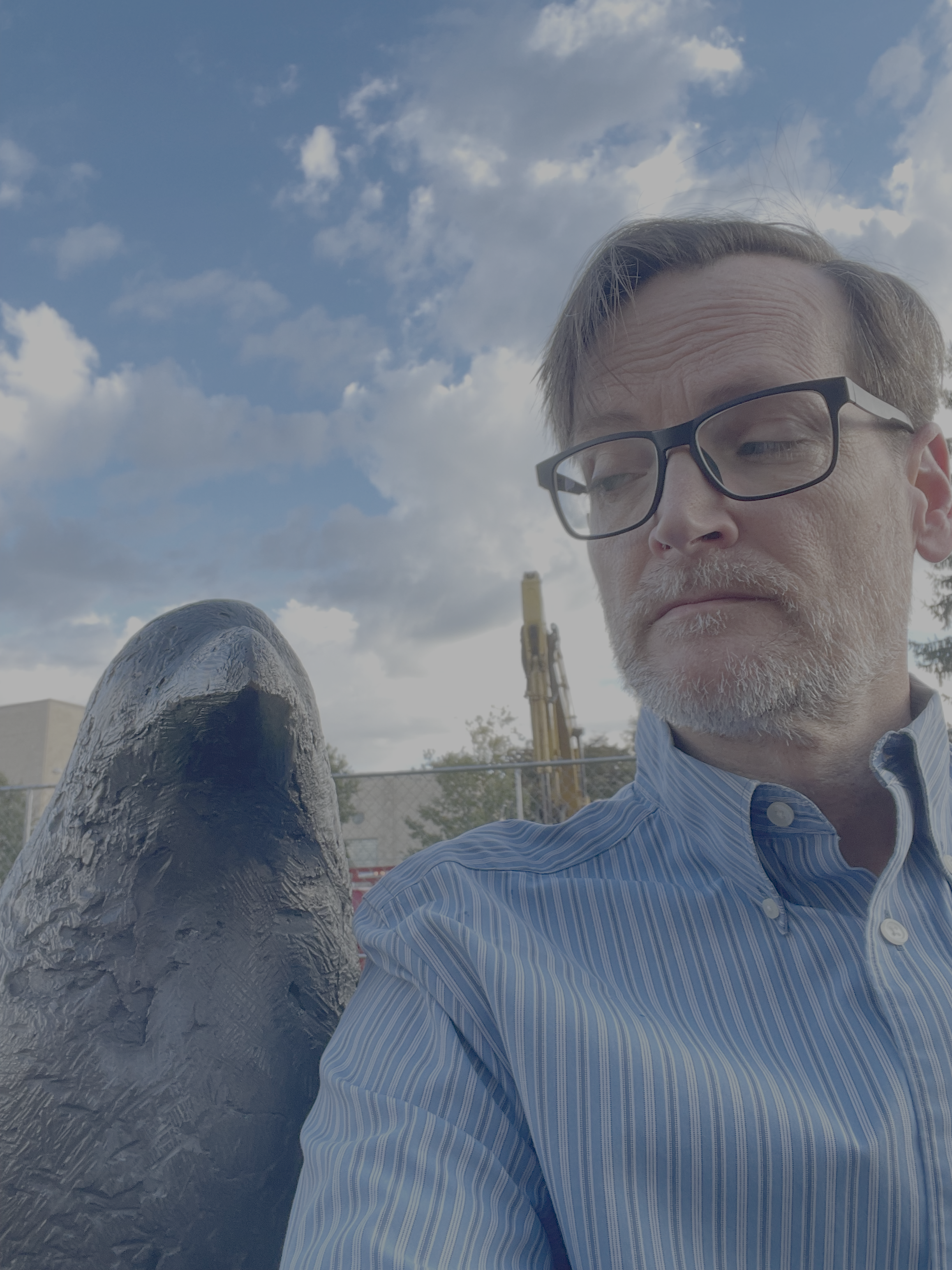 A photo of a Kevin McGowan (right) and a corvid-shaped object